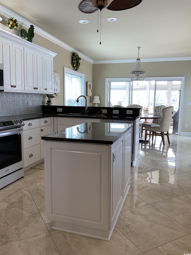 1605 Waterway Dr, North Myrtle Beach, SC 29582 - kitchen featuring appliances with stainless steel finishes, light marble finish floors, ornamental molding, white cabinets, and a peninsula
