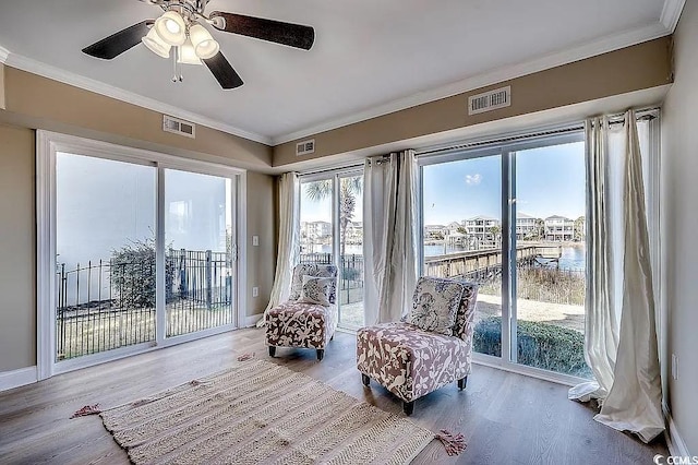 1605 Waterway Dr, North Myrtle Beach, SC 29582 - living area featuring crown molding, wood finished floors, a ceiling fan, and a water view