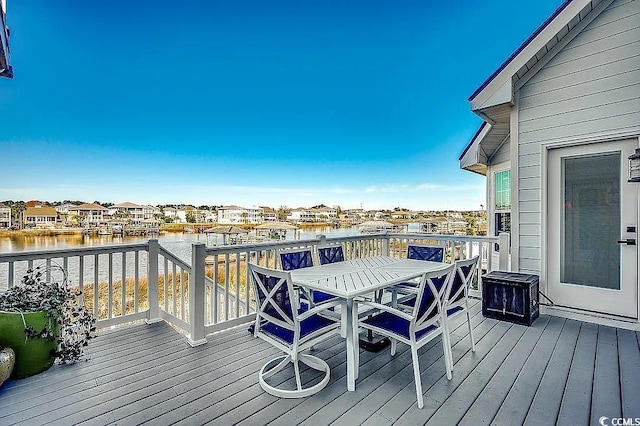 1605 Waterway Dr, North Myrtle Beach, SC 29582 - wooden deck featuring a water view, outdoor dining space, and a residential view