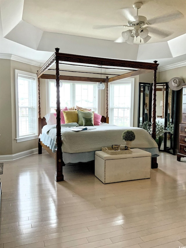 1605 Waterway Dr, North Myrtle Beach, SC 29582 - bedroom featuring a raised ceiling, multiple windows, ornamental molding, wood-type flooring, and ceiling fan