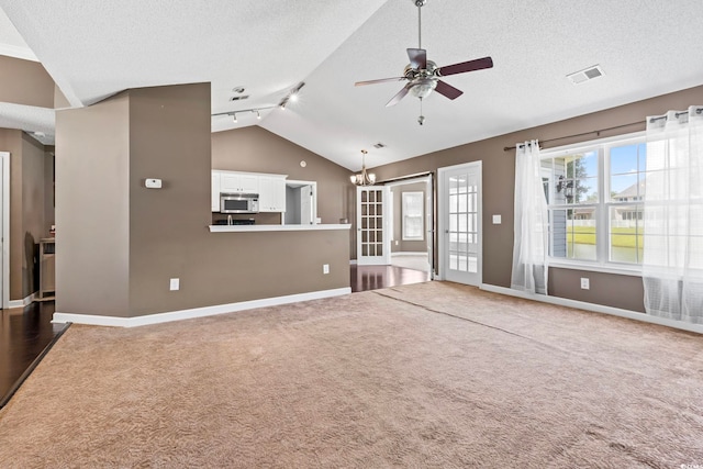 127 Ashworth Dr, Little River, SC 29566 - unfurnished living room with vaulted ceiling, ceiling fan, carpet floors, a chandelier, and a textured ceiling