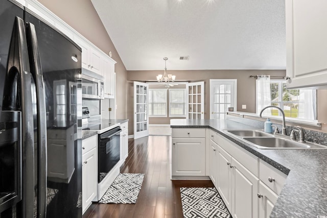 127 Ashworth Dr, Little River, SC 29566 - kitchen featuring fridge with ice dispenser, stainless steel microwave, range with electric cooktop, a chandelier, and lofted ceiling