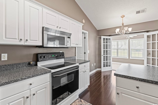 127 Ashworth Dr, Little River, SC 29566 - kitchen featuring stainless steel microwave, electric range, vaulted ceiling, a chandelier, and white cabinetry
