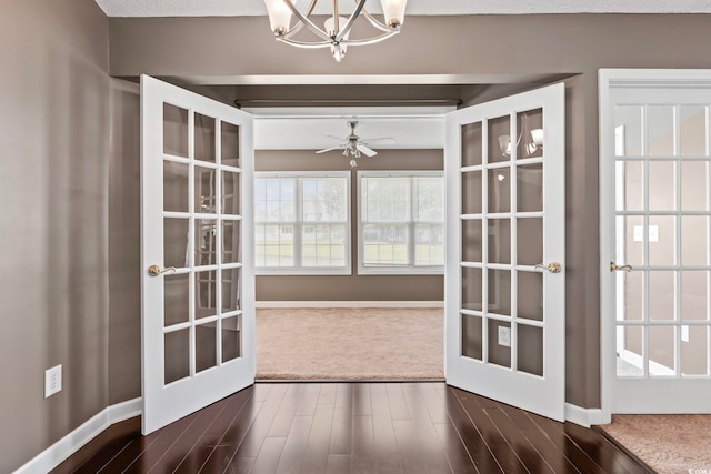 127 Ashworth Dr, Little River, SC 29566 - unfurnished dining area with french doors, dark wood-style floors, a chandelier, and ceiling fan