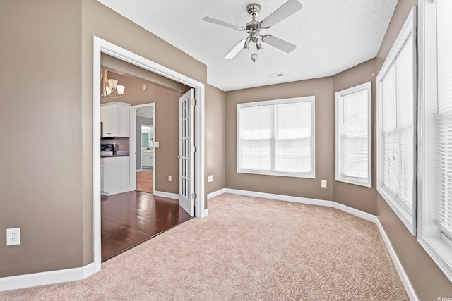 127 Ashworth Dr, Little River, SC 29566 - unfurnished room with carpet, plenty of natural light, ceiling fan, and a chandelier