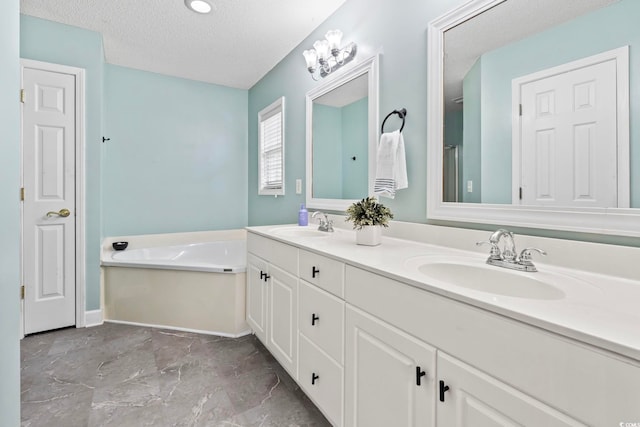 127 Ashworth Dr, Little River, SC 29566 - bathroom featuring double vanity, a textured ceiling, and a bath