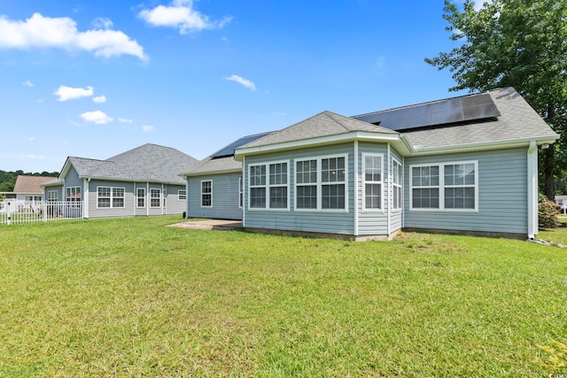 127 Ashworth Dr, Little River, SC 29566 - rear view of house featuring roof mounted solar panels, a patio, and roof with shingles