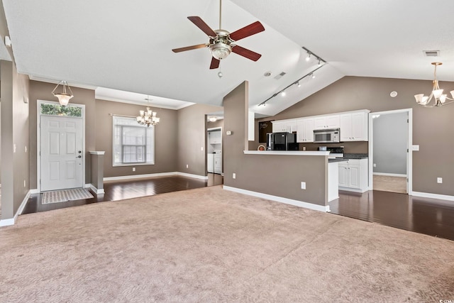 127 Ashworth Dr, Little River, SC 29566 - unfurnished living room featuring a chandelier, dark colored carpet, rail lighting, and high vaulted ceiling