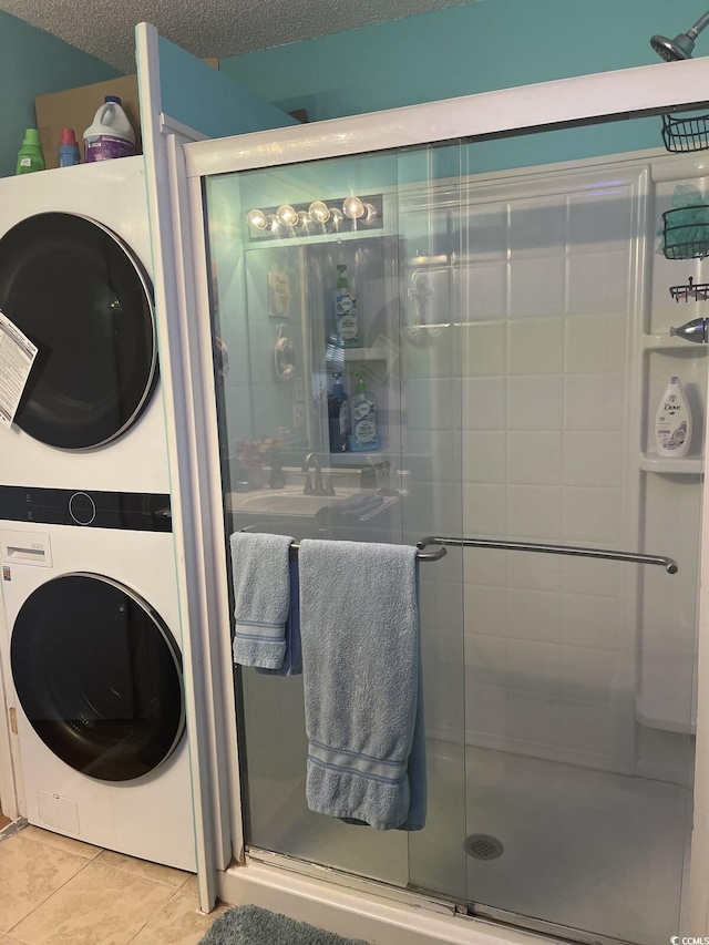 6001-5723 Kings Hwy, Myrtle Beach, SC 29575 - full bathroom featuring estacked washer and dryer, tile patterned floors, and a stall shower