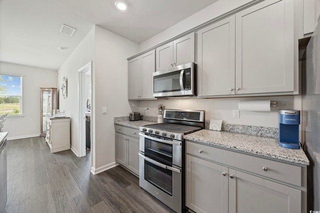 305 Picnic Basket Pl, Longs, SC 29568 - kitchen featuring stainless steel appliances, gray cabinetry, dark wood-style flooring, light stone counters, and recessed lighting
