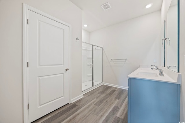 305 Picnic Basket Pl, Longs, SC 29568 - bathroom with a shower stall, double vanity, wood finished floors, and recessed lighting