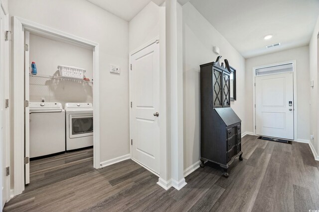 305 Picnic Basket Pl, Longs, SC 29568 - washroom with washer and clothes dryer, dark wood-style flooring, and a wood stove