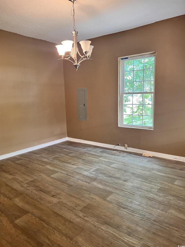 1706 Foster St, Conway, SC 29527 - empty room featuring a chandelier, dark wood finished floors, electric panel, and a textured ceiling