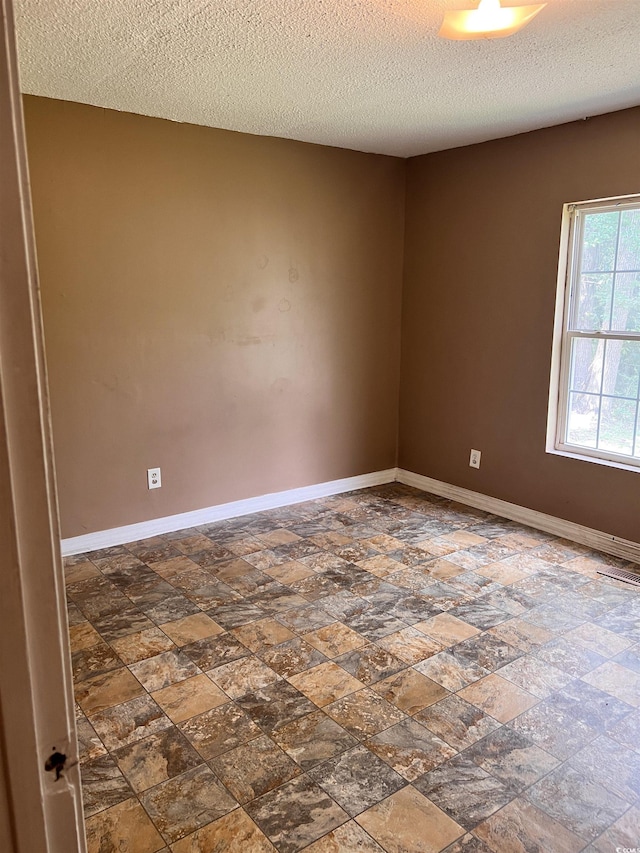 1706 Foster St, Conway, SC 29527 - empty room with dark stone finish flooring and a textured ceiling