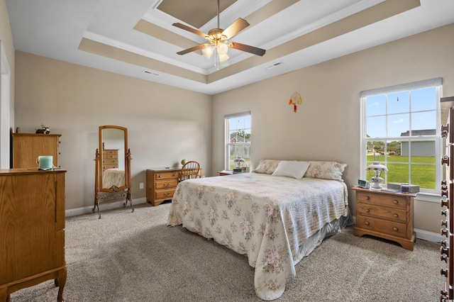 215 Vineyard Lake Cir, Conway, SC 29527 - bedroom with a tray ceiling, light carpet, and a ceiling fan