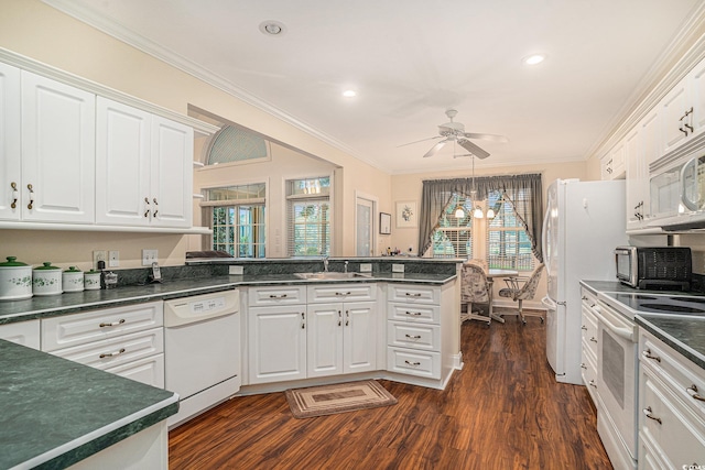 285 Georgetown Dr, Pawleys Island, SC 29585 - kitchen with white appliances, dark countertops, white cabinets, crown molding, and recessed lighting