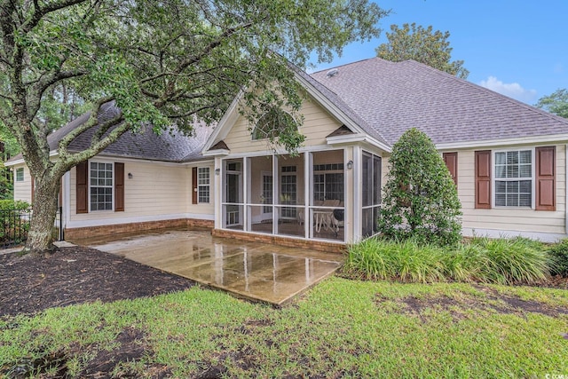 285 Georgetown Dr, Pawleys Island, SC 29585 - back of house with a sunroom, a shingled roof, and a yard