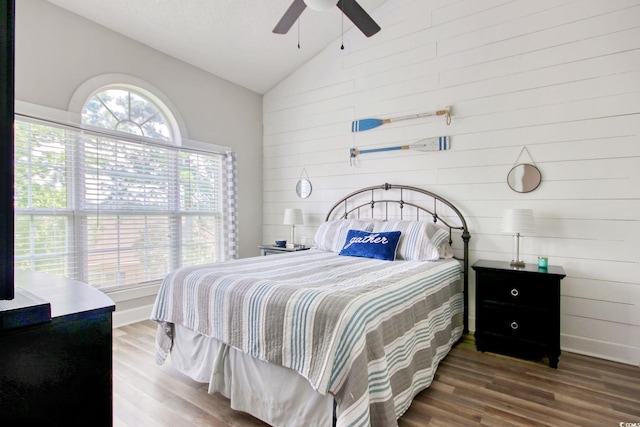 4179 Hibiscus Dr Unit 12-301, Little River, SC 29566 - bedroom with lofted ceiling, wooden walls, wood finished floors, and a ceiling fan