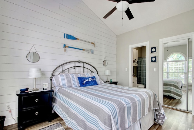 4179 Hibiscus Dr Unit 12-301, Little River, SC 29566 - bedroom with vaulted ceiling, wood finished floors, wood walls, and a ceiling fan
