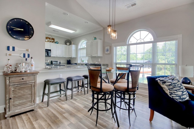 4179 Hibiscus Dr Unit 12-301, Little River, SC 29566 - dining space with light wood-style flooring and vaulted ceiling