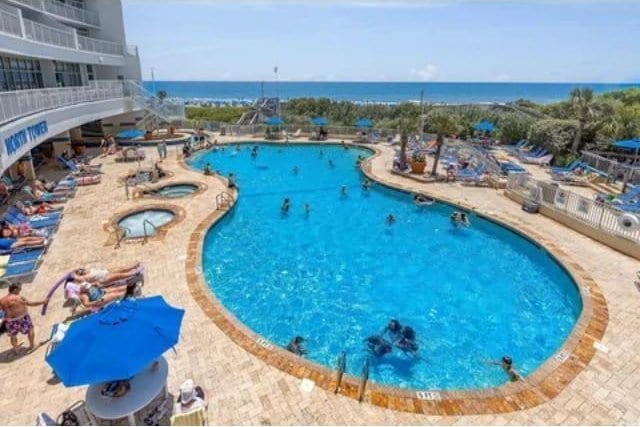 158 Sea Watch Dr Unit 707, Myrtle Beach, SC 29572 - community pool featuring a water view, a community hot tub, and a patio