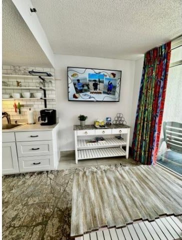 158 Sea Watch Dr Unit 707, Myrtle Beach, SC 29572 - living area with a textured ceiling and wood finished floors