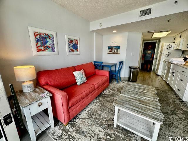 158 Sea Watch Dr Unit 707, Myrtle Beach, SC 29572 - living area with a textured ceiling