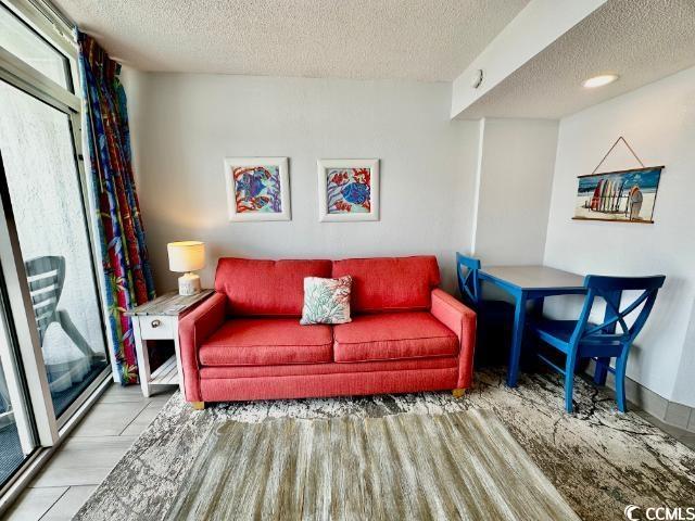 158 Sea Watch Dr Unit 707, Myrtle Beach, SC 29572 - living room featuring a textured ceiling