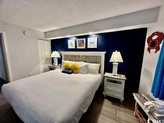 158 Sea Watch Dr Unit 707, Myrtle Beach, SC 29572 - bedroom with a textured ceiling and a closet