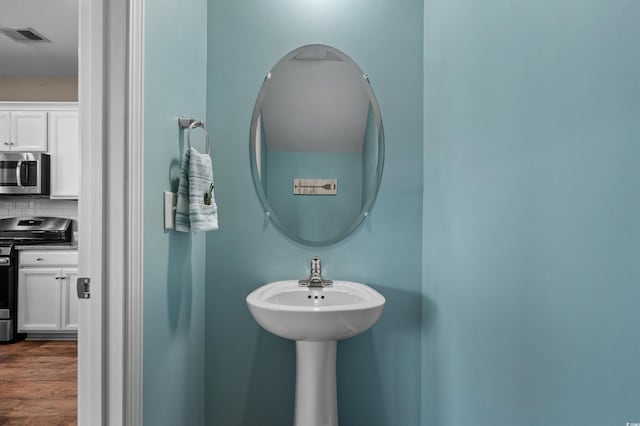 4737 Seclusion Ln, Myrtle Beach, SC 29577 - bathroom featuring wood finished floors and backsplash