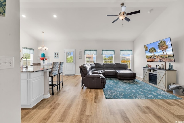 325 Cardita Loop, Myrtle Beach, SC 29588 - living area featuring high vaulted ceiling, light wood finished floors, a chandelier, ceiling fan, and healthy amount of natural light