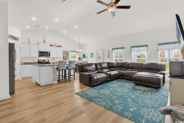 325 Cardita Loop, Myrtle Beach, SC 29588 - living room featuring high vaulted ceiling, a ceiling fan, a chandelier, light wood-style floors, and recessed lighting