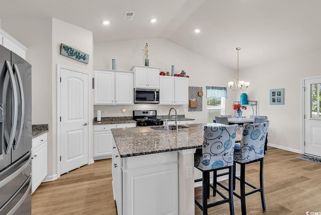325 Cardita Loop, Myrtle Beach, SC 29588 - kitchen featuring stainless steel appliances, a kitchen bar, white cabinets, plenty of natural light, and high vaulted ceiling
