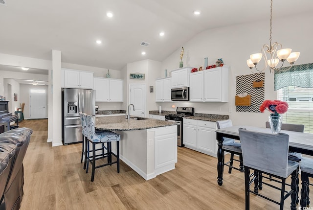 325 Cardita Loop, Myrtle Beach, SC 29588 - kitchen featuring appliances with stainless steel finishes, a kitchen breakfast bar, a chandelier, vaulted ceiling, and white cabinetry