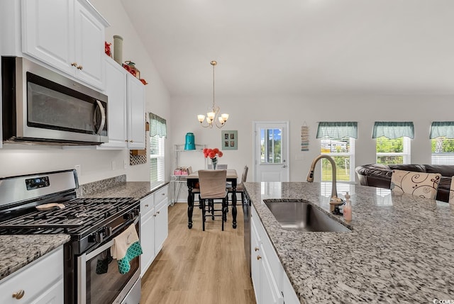 325 Cardita Loop, Myrtle Beach, SC 29588 - kitchen featuring stainless steel appliances, a chandelier, light wood-type flooring, white cabinets, and plenty of natural light