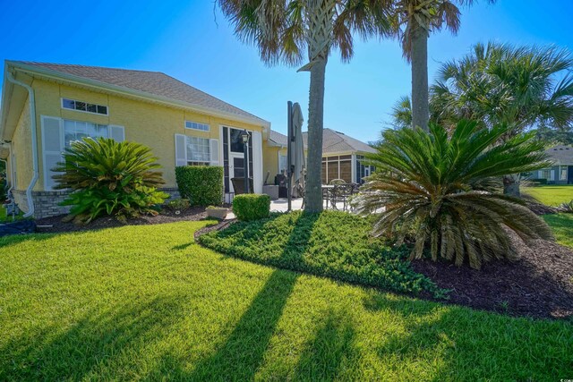 530 Inverarry St, Murrells Inlet, SC 29576 - view of front of house with a front yard, stucco siding, and a patio