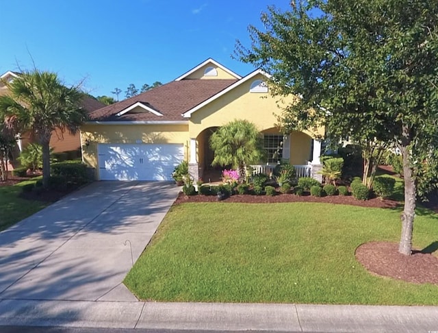 530 Inverarry St, Murrells Inlet, SC 29576 - view of front facade with a front lawn, an attached garage, stucco siding, driveway, and a porch