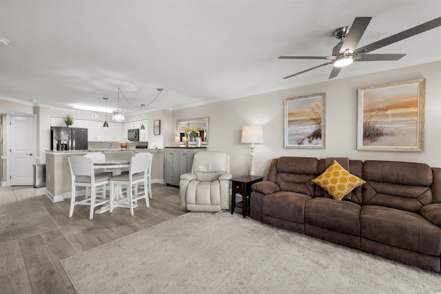 1819 N Ocean Blvd Unit 1518, North Myrtle Beach, SC 29582 - living room featuring light wood-style flooring, ornamental molding, and a ceiling fan