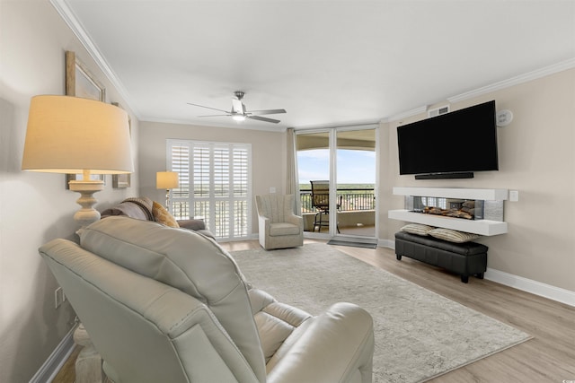 1819 N Ocean Blvd Unit 1518, North Myrtle Beach, SC 29582 - living room featuring a ceiling fan, ornamental molding, plenty of natural light, and wood finished floors