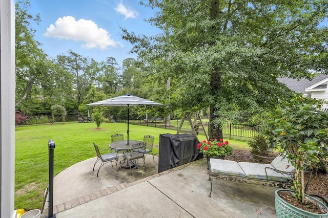 175 Chapel Creek Rd, Pawleys Island, SC 29585 - fenced backyard featuring a patio, grilling area, and outdoor dining area