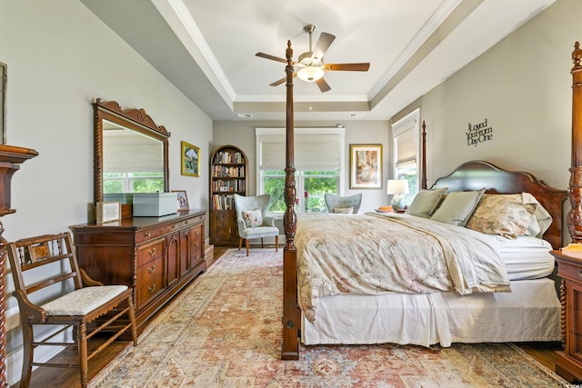 175 Chapel Creek Rd, Pawleys Island, SC 29585 - bedroom featuring multiple windows, a raised ceiling, light wood-style floors, and ornamental molding