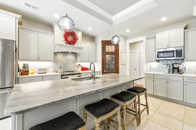 175 Chapel Creek Rd, Pawleys Island, SC 29585 - kitchen with stainless steel appliances, backsplash, a breakfast bar area, recessed lighting, and crown molding