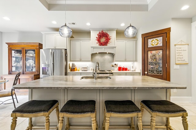 175 Chapel Creek Rd, Pawleys Island, SC 29585 - kitchen featuring stainless steel refrigerator with ice dispenser, decorative backsplash, recessed lighting, a tray ceiling, and light tile patterned floors