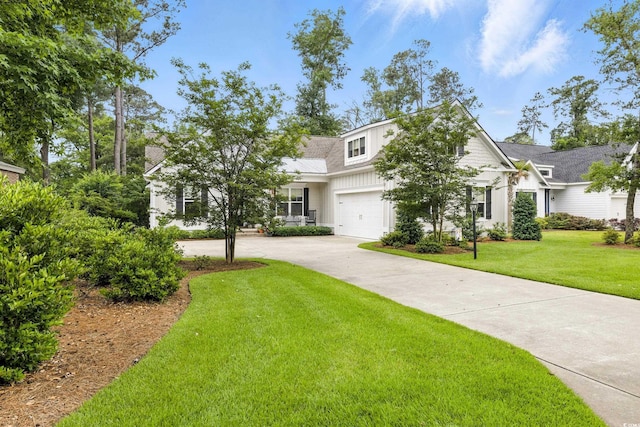 175 Chapel Creek Rd, Pawleys Island, SC 29585 - view of front of house with driveway, a front lawn, a garage, and board and batten siding