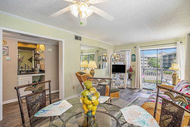 207 N Ocean Blvd Unit 139, North Myrtle Beach, SC 29582 - living room with wood finished floors, ceiling fan, a textured ceiling, bar, and ornamental molding
