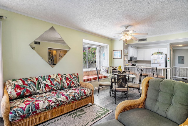 207 N Ocean Blvd Unit 139, North Myrtle Beach, SC 29582 - living room with wood finished floors, crown molding, ceiling fan, a textured ceiling, and electric panel
