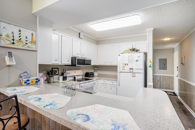 207 N Ocean Blvd Unit 139, North Myrtle Beach, SC 29582 - kitchen featuring white appliances, light countertops, a peninsula, white cabinetry, and crown molding