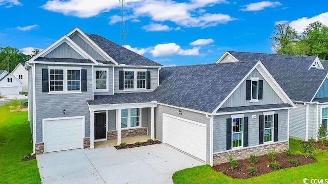 1012 Fowler Rd, Conway, SC 29526 - craftsman house featuring stone siding, driveway, a front yard, and roof with shingles