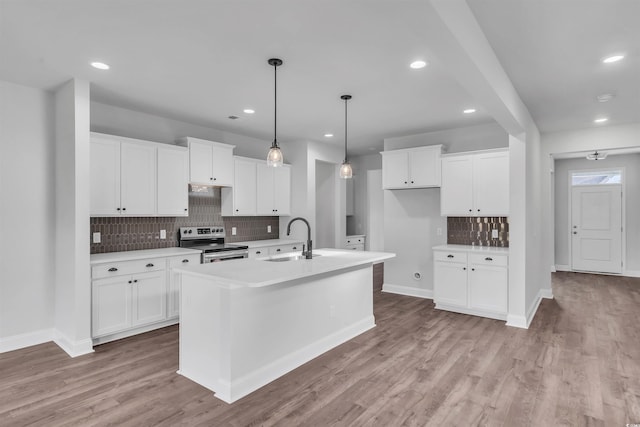 1012 Fowler Rd, Conway, SC 29526 - kitchen featuring electric range, decorative backsplash, light countertops, white cabinets, and light wood finished floors