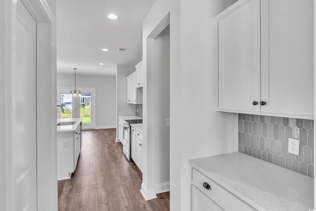 1012 Fowler Rd, Conway, SC 29526 - kitchen featuring stainless steel electric stove, decorative backsplash, white cabinetry, dark wood-style floors, and recessed lighting